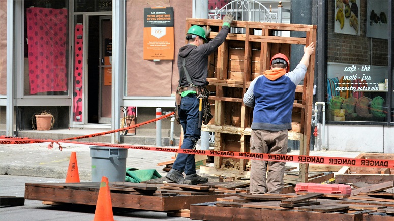 Workers lifting pallets.